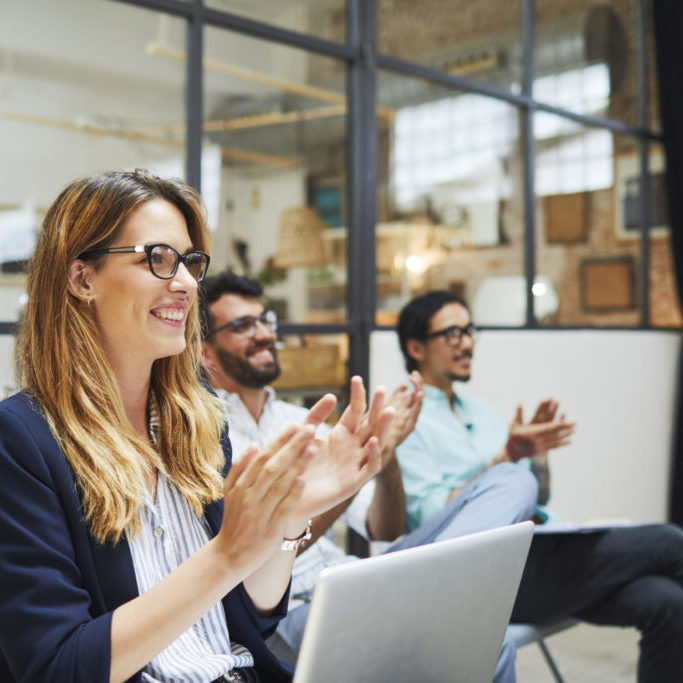 people clapping in a meeting